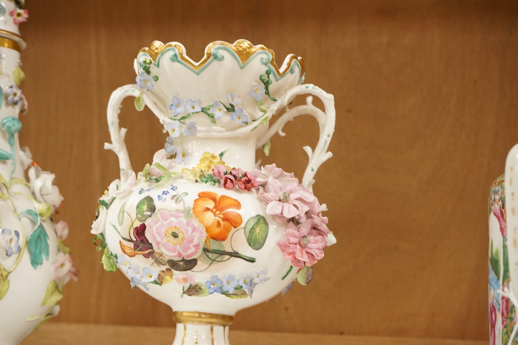 An English porcelain flower encrusted scent bottle and stoppers and a similar vase, c.1835, tallest 28cm